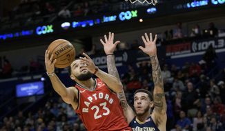 Toronto Raptors guard Fred VanVleet (23) shoots next to New Orleans Pelicans guard Lonzo Ball (2) during the first half of an NBA basketball game in New Orleans, Friday, Nov. 8, 2019. (AP Photo/Matthew Hinton)