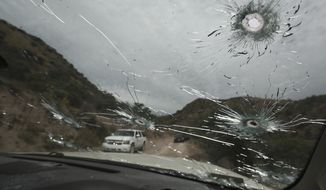 Bullet-riddled vehicles that members of the extended LeBaron family were traveling in sit parked on a dirt road near Bavispe, at the Sonora-Chihuahua state border, Mexico, Wednesday, Nov. 6, 2019. Three women and six of their children, related to the extended LeBaron family, were gunned down in an attack while traveling here Monday. (AP Photo/Christian Chavez)