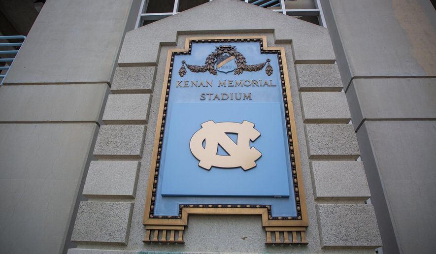 A plaque commemorating William Rand Kenan Sr., at Kenan Memorial Stadium is covered by the UNC-Chapel Hill logo on Thursday, Nov. 7, 2019, in Chapel Hill, NC. Last year, then-Chancellor Carol Folt said the university would remove references to Kenan and instead focus on his son, William Rand Kenan Jr., who paid to have the stadium dedicated to his parents’ memory. Sportswriter Craig Calcaterra had reported the elder Kenan was the commander of "a white supremacist paramilitary force which massacred scores of black residents of Wilmington." (Casey Toth/The News & Observer via AP)
