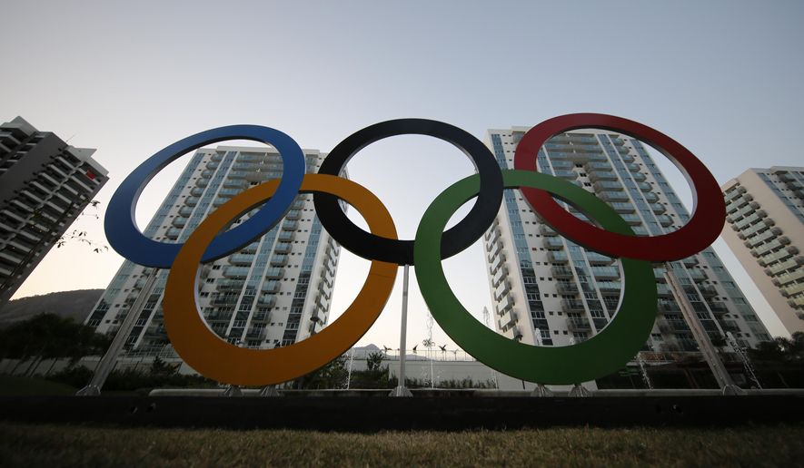 FILE - In this July 23, 2016, file photo, a representation of the Olympic rings are displayed in the Olympic Village in Rio de Janeiro, Brazil. The U.S. Olympic and Paralympic Committee will add athletes to its board and enhance its oversight of individual sports organizations. It’s part of a package of reforms stemming from the Larry Nassar sex-abuse scandal. The reforms were approved Thursday, Nov. 8, 2019 and go into effect in January. (AP Photo/Leo Correa, File)