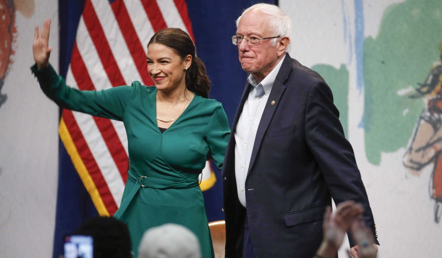 Rep. Alexandria Ocasio-Cortez, D-N.Y stands alongside Democratic presidential candidate Sen. Bernie Sanders, I-Vt., during a campaign rally on Saturday, Nov. 9, 2019, at Drake University in Des Moines, Iowa.  (Bryon Houlgrave /The Des Moines Register via AP)