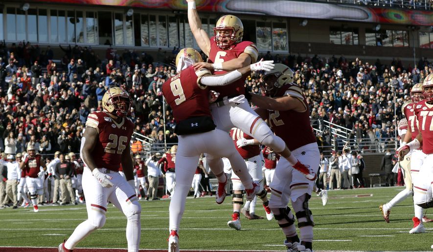 Boston College quarterback Dennis Grosel, top, celebrates his touchdown pass to wide receiver Kobay White (9) in the first half of an NCAA college football game against Florida State, Saturday, Nov. 9, 2019, in Boston. (AP Photo/Bill Sikes)