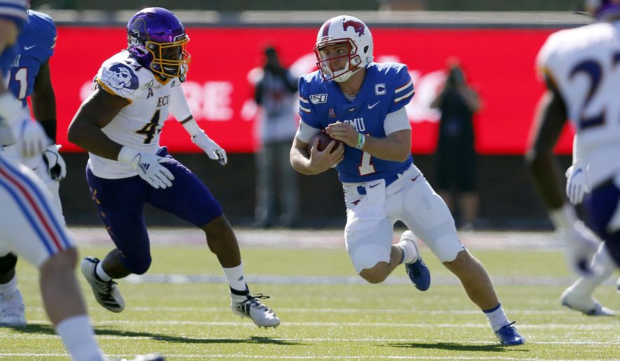 SMU quarterback Shane Buechele (7) looks for room to run while East Carolina cornerback Malik Fleming (4) gives chase during the first half of an NCAA college football game, Saturday, Nov. 9, 2019, in Dallas. (AP Photo/Roger Steinman)