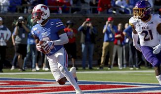 SMU wide receiver James Proche, left, catches a touchdown pass while East Carolina cornerback Ja&#39;Quan McMillian (21) looks on during the second half of an NCAA college football game, Saturday, Nov. 9, 2019, in Dallas. (AP Photo/Roger Steinman)