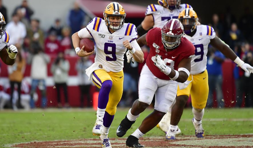 LSU quarterback Joe Burrow (9) runs as Alabama defensive lineman Phidarian Mathis (48) chases him in the first half of an NCAA college football game, Saturday, Nov. 9, 2019, in Tuscaloosa , Ala. (AP Photo/Vasha Hunt)