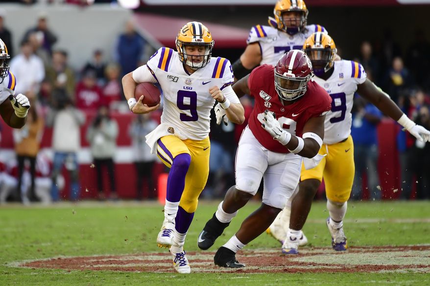 LSU quarterback Joe Burrow (9) runs as Alabama defensive lineman Phidarian Mathis (48) chases him in the first half of an NCAA college football game, Saturday, Nov. 9, 2019, in Tuscaloosa , Ala. (AP Photo/Vasha Hunt)
