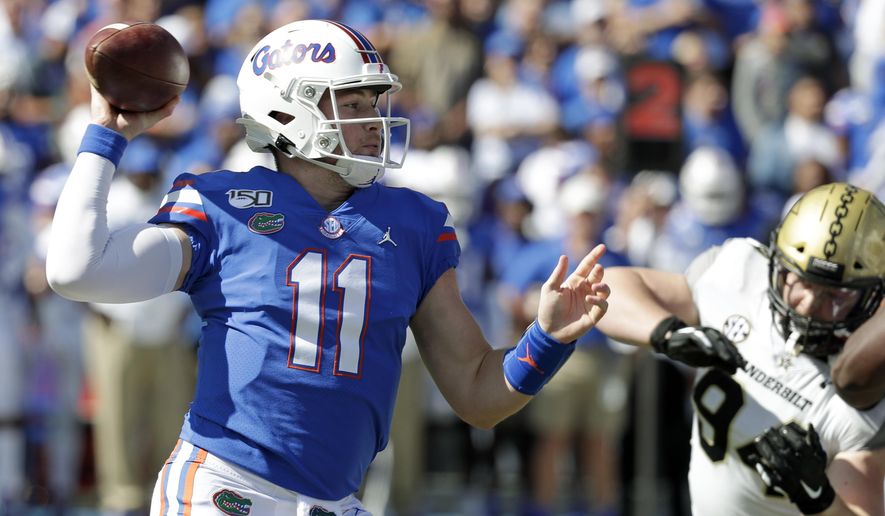 Florida quarterback Kyle Trask (11) throws a pass as he is pressured by Vanderbilt defensive lineman Rutger Reitmaier, right, during the first half of an NCAA college football game, Saturday, Nov. 9, 2019, in Gainesville, Fla. (AP Photo/John Raoux)
