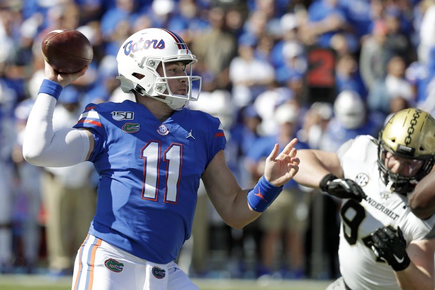 Florida quarterback Kyle Trask (11) throws a pass as he is pressured by Vanderbilt defensive lineman Rutger Reitmaier, right, during the first half of an NCAA college football game, Saturday, Nov. 9, 2019, in Gainesville, Fla. (AP Photo/John Raoux)