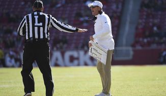 Arkansas coach Chad Morris talks with an official while playing Western Kentucky during the second half of an NCAA college football game, Saturday, Nov. 9, 2019 in Fayetteville, Ark. (AP Photo/Michael Woods)