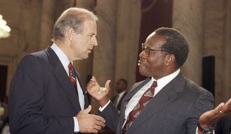 In this file photo, then-D.C. Circuit Court of Appeals Judge larence Thomas gestures while talking with Sen. Joseph Biden, D-Del., chairman of the Senate Judiciary Committee, during a break in the committee&#39;s Supreme Court nomination hearing for Thomas on Capitol Hill in Washington, Friday, Sept. 13, 1991. Associated Press) **FILE**