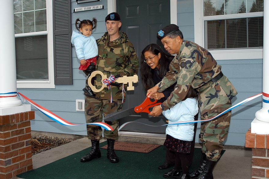 Retired Lt. Gen. Edward Soriano, then I Corps commanding general, along with an Army family, cut the ceremonial ribbon to dedicate the new 108-unit Beachwood II housing area on Lewis North, built under the Residential Communities Initiative in 2002. Photo by Mike Cullum, JBLM Enterprise Media Center.
