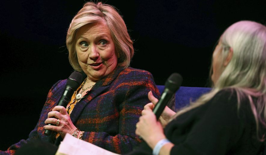US former Secretary of State Hillary Clinton, left, talks to Classicist Mary Beard, at the Southbank Centre in London during the launch of Gutsy Women: Favorite Stories of Courage and Resilience, a book by Chelsea and Hillary Clinton, in London, Sunday, Nov. 10, 2019. (Aaron Chown/PA via AP)