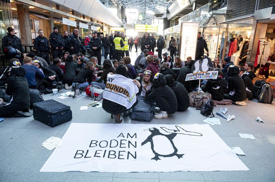Climate activists block the entrance hall of the Tegel airport in Berlin, Germany, Sunday, Nov. 10, 2019. (Fabian Sommer/dpa via AP)
