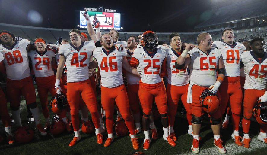 Members of the Illinois football team sing at the end of the team's NCAA college football game against Michigan State, Saturday, Nov. 9, 2019, in East Lansing, Mich. (AP Photo/Carlos Osorio)