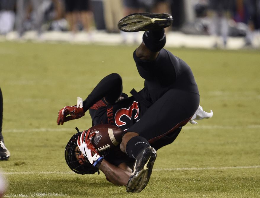 San Diego State cornerback Darren Hall (23) flips as he intercepts a pass during the first half of a college football game against Nevada Saturday, Nov. 9, 2019, in San Diego. CA. (AP Photo/Denis Poroy)