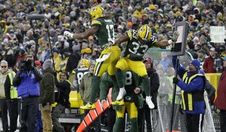 Green Bay Packers&#39; Aaron Jones celebrates his touchdown run with Davante Adams during the first half of an NFL football game against the Carolina Panthers Sunday, Nov. 10, 2019, in Green Bay, Wis. (AP Photo/Mike Roemer)