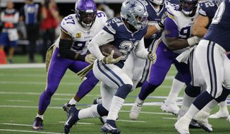 Dallas Cowboys running back Ezekiel Elliott (21) carries the ball as Minnesota Vikings&#39; Everson Griffen (97) gives chase during the second half of an NFL football game in Arlington, Texas, Sunday, Nov. 10, 2019. (AP Photo/Michael Ainsworth)