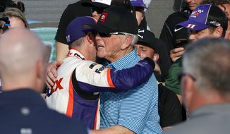 Denny Hamlin, left, embraces car owner Joe Gibbs in victory lane after winning the NASCAR Cup Series auto race at ISM Raceway, Sunday, Nov. 10, 2019, in Avondale, Ariz. (AP Photo/Ralph Freso) **FILE**