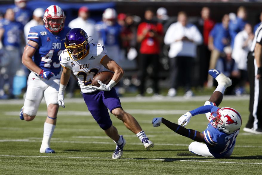 East Carolina receiver Tyler Snead (22) advances the ball after SMU safety Chace Cromartie, right, misses a tackle during the second half of an NCAA college football game, Saturday, Nov. 9, 2019, in Dallas. (AP Photo/Roger Steinman)