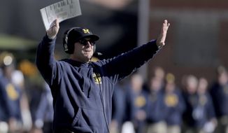 Michigan head coach Jim Harbaugh gestures toward his team during the second half of an NCAA college football game against Maryland, Saturday, Nov. 2, 2019, in College Park, Md. Michigan won 38-7. (AP Photo/Julio Cortez)