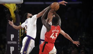 Los Angeles Lakers&#39; Anthony Davis, left, blocks a shot from Toronto Raptors&#39; Pascal Siakam (43) during the first half of an NBA basketball game Sunday, Nov. 10, 2019, in Los Angeles. (AP Photo/Marcio Jose Sanchez)