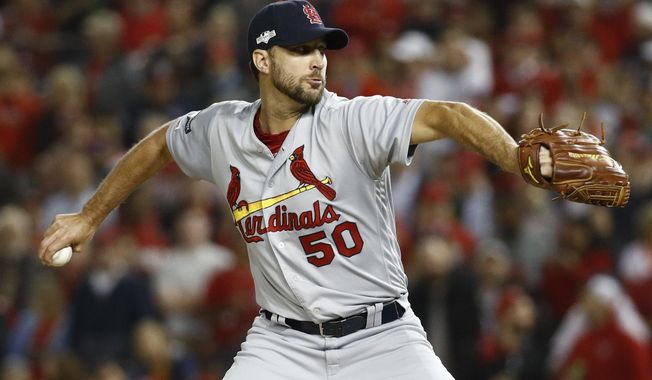 FILE - In this Oct. 15, 2019, file photo, St. Louis Cardinals relief pitcher Adam Wainwright throws during the second inning of Game 4 of the baseball National League Championship Series, in Washington. The St. Louis Cardinals and Adam Wainwright have agreed to a contract for next season, raising the likelihood that the veteran pitcher finishes his career with the only major league team he has ever played for.Terms of the deal Tuesday, Nov. 12, 2019, were not disclosed.(AP Photo/Patrick Semansky, File)