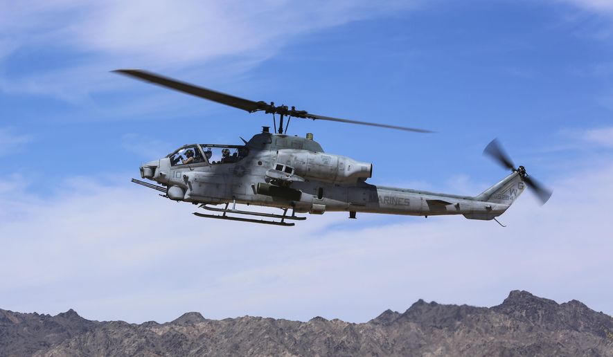 FILE - In this April 17, 2017 file photo released by U.S. Marine Corps, an AH-1Z Viper prepares to land at the Chocolate Mountain Aerial Gunnery Range, Calif. On Tuesday Nov. 12, 2019, the Czech defense minister says the government is planning to sign a deal with the U.S. counterpart to purchase 12 military helicopters. The Czechs will get eight UH-1Y Venom chopters and four AH-1Z Viper ones. (Cpl. Harley Robinson/U.S. Marine Corps via AP/File)