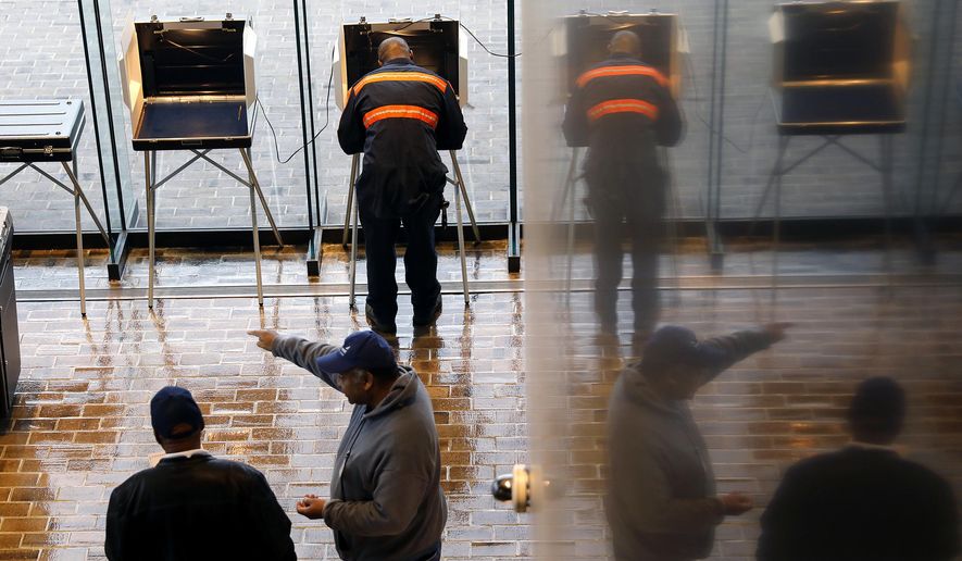 FILE - In this Nov. 5, 2019, file photo, voters cast their ballots at Hampton City Hall, in Hampton, Va. As election results came in last week from Kentucky and Virginia, social media posts offered an unsubstantiated explanation for Republican losses: voter fraud. The responses offer a glimpse into the type of misinformation that could cloud next year’s presidential race. (Jonathon Gruenke/The Virginian-Pilot via AP, File)