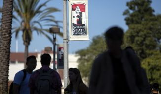 People walk on campus at San Diego State University Tuesday, Nov. 12, 2019, in San Diego, Calif. San Diego State University says a freshman who was hospitalized after attending a fraternity party last week has died. University President Adela de la Torre announced Monday that 19-year-old Dylan Hernandez died Sunday, Nov. 10, 2019 surrounded by his family.The university says its police are investigating the death but gave no further details about possible causes. (AP Photo/Gregory Bull)
