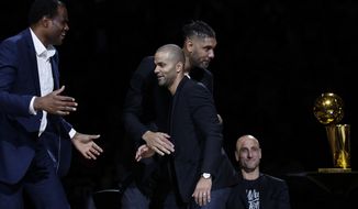 Former San Antonio Spurs guard Tony Parker, front center, is congratulated by former teammates, from left, David Robinson, Tim Duncan and Manu Ginobili, seated, during Parker&#39;s retirement ceremony after the team&#39;s NBA basketball game against the Memphis Grizzlies in San Antonio, Monday, Nov. 11, 2019. (AP Photo/Eric Gay)