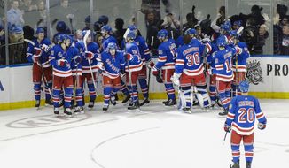 The New York Rangers celebrate after an NHL hockey game against the Pittsburgh Penguins Tuesday, Nov. 12, 2019, in New York. The Rangers won 3-2 in overtime. (AP Photo/Frank Franklin II)