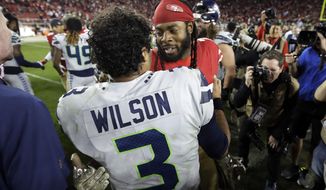 Seattle Seahawks quarterback Russell Wilson (3) greets San Francisco 49ers cornerback Richard Sherman after an NFL football game in Santa Clara, Calif., Monday, Nov. 11, 2019. The Seahawks won 27-24 in overtime. (AP Photo/Ben Margot)