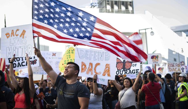Ernesto Parada, 28, a graduate student at California State University, Northridge, marches Tuesday, Nov. 12, 2019, through downtown Los Angeles to MacArthur Park, to defend the Deferred Action for Childhood Arrivals program while the U.S. Supreme Court considers the fate of the Obama-era immigration program being challenged by the Trump administration. (Sarah Reingewirtz/The Orange County Register/SCNG via AP)