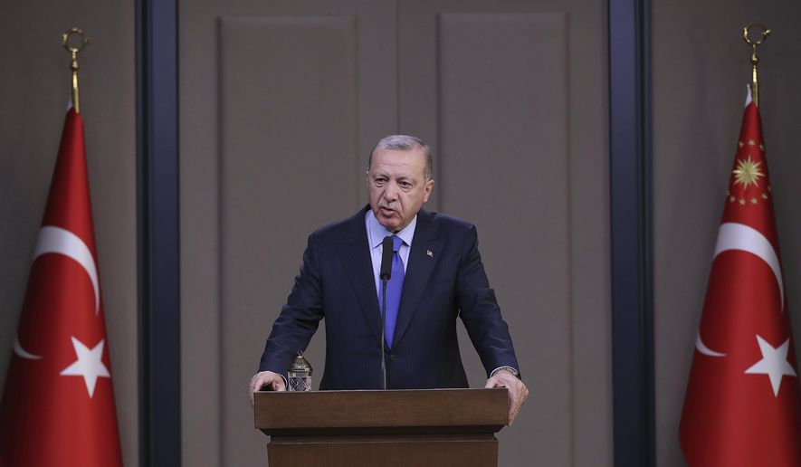 Turkish President Recep Tayyip Erdogan speaks to reporters before a visit to the United States, in Ankara, Turkey, Tuesday, Nov. 12, 2019. Erdogan warned European nations Tuesday that his country could release all the Islamic State group prisoners it holds and send them to Europe, in response to EU sanctions over Cyprus.(Presidential Press Service via AP, Pool)