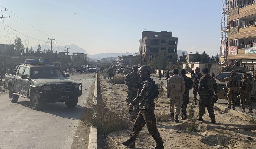 Afghan security personnel gather at the site of an explosion in Kabul, Afghanistan, Wednesday, Nov. 13, 2019. An explosion has rocked the Afghan capital of Kabul as early morning commuters were on the street heading to work. (AP Photo/Rahmat Gul)