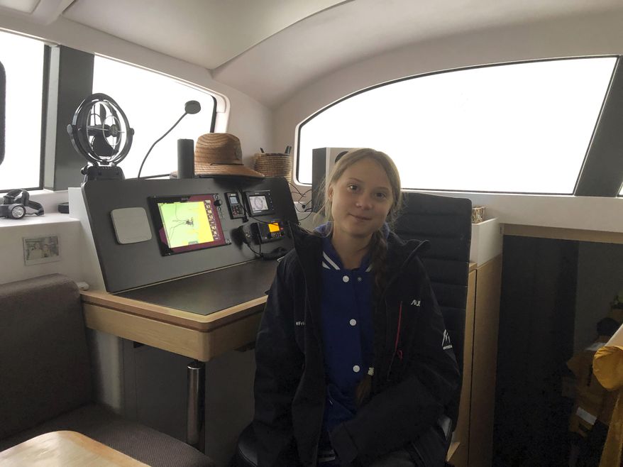 Greta Thunberg, a 16-year-old climate activist from Sweden, sits on a catamaran docked in Hampton, Va., on Tuesday, Nov. 12, 2019. Thunberg will leave North America and begin her return trip across the Atlantic on Wednesday aboard a 48-foot (15-meter) catamaran sailboat whose passengers include an 11-month-old baby.The boat leaves little to no carbon footprint, boasting solar panels and a hydro-generators for power. (AP Photo/Ben Finley)