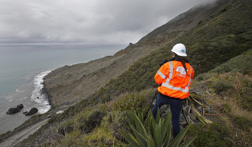 File - In this May 25, 2017, file photo, Cal Trans public affairs officer Jessica Biro photographs the southern end of the Mud Creek slide as it covers Highway One in southern Monterey County on the coast in Big Sur, Calif. The California Department of Transportation plans to temporarily close landslide-plagued Highway 1 on the southern Big Sur coast when there are forecasts of significant rains this winter. The Monterey Herald reports Caltrans will notify the public 48 hours before any potential closures, which would take place at Mud Creek or Paul's Slide. (Vern Fisher/The Monterey County Herald via AP, File)