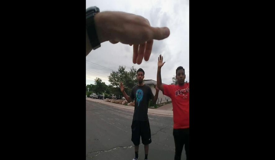 FILE - In this Aug. 3, 2019, file photo from police body camera video from the Colorado Springs, Colo., Police Department shows the first in a sequence of photos of a confrontation between officers and De'Von Bailey, 19, center. A grand jury has found that two Colorado police officers were justified when they shot and killed Bailey during a foot chase. KRDO-TV reports El Paso County District Attorney Dan May announced the decision Wednesday, Nov. 13, 2019, in the Aug. 3 death of Bailey in Colorado Springs. Bailey was shot three times in the back and once in the arm while running from police. (Colorado Springs Police Department via AP, File)