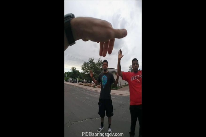 FILE - In this Aug. 3, 2019, file photo from police body camera video from the Colorado Springs, Colo., Police Department shows the first in a sequence of photos of a confrontation between officers and De'Von Bailey, 19, center. A grand jury has found that two Colorado police officers were justified when they shot and killed Bailey during a foot chase. KRDO-TV reports El Paso County District Attorney Dan May announced the decision Wednesday, Nov. 13, 2019, in the Aug. 3 death of Bailey in Colorado Springs. Bailey was shot three times in the back and once in the arm while running from police. (Colorado Springs Police Department via AP, File)