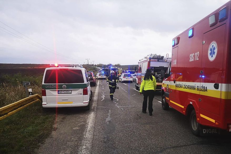 Emergency workers attend the scene after a passenger bus collided with a truck Wednesday Nov. 13, 2019, near the town of Nitranske Hrnciarovce, Slovakia, Wednesday Nov. 13, 2019. Officials say at least 13 people have died in the accident with about 20 injured, some seriously. (HaZZ-Presidium of Fire and Rescue Corps via AP)