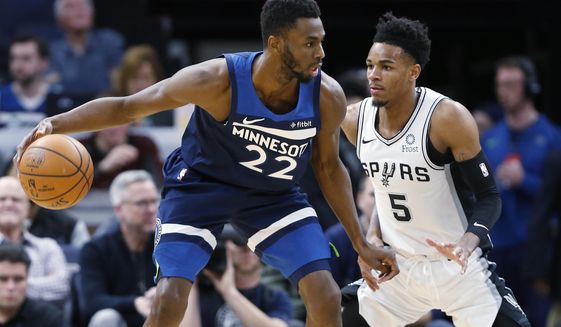 Minnesota Timberwolves&#39; Andrew Wiggins, left, drives around San Antonio Spurs&#39; Dejounte Murray in the first half of an NBA basketball game Wednesday, Nov 13, 2019, in Minneapolis. (AP Photo/Jim Mone)