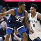 Minnesota Timberwolves&#39; Andrew Wiggins, left, drives around San Antonio Spurs&#39; Dejounte Murray in the first half of an NBA basketball game Wednesday, Nov 13, 2019, in Minneapolis. (AP Photo/Jim Mone)