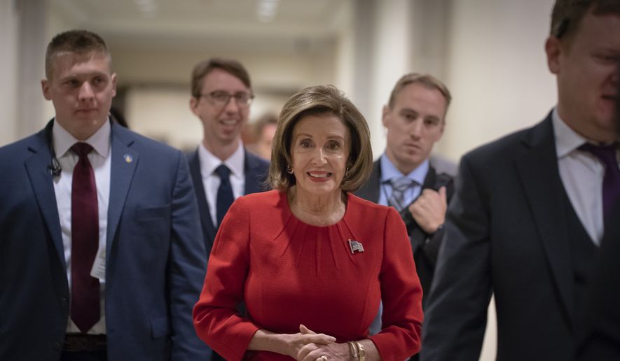 Speaker of the House Nancy Pelosi, D-Calif., arrives to talk to reporters on the morning after the first public hearing in the impeachment probe of President Donald Trump on his effort to tie U.S. aid for Ukraine to investigations of his political opponents, on Capitol Hill in Washington, Thursday, Nov. 14, 2019. Pelosi says the president's actions in the impeachment inquiry amount to "bribery." (AP Photo/J. Scott Applewhite)