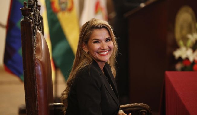 The opposition senator who has claimed Bolivia&#x27;s presidency Jeanine Anez smiles during the swearing-in ceremony of her new Cabinet at the presidential palace in La Paz, Bolivia, Wednesday, Nov. 13, 2019. Anez faces the challenge of stabilizing the nation and organizing national elections within three months at a time of political disputes that pushed former President Evo Morales to fly off to self-exile in Mexico after 14 years in power. (AP Photo/Juan Karita)