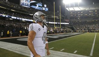 Oakland Raiders quarterback Derek Carr (4) celebrates after the Raiders defeated the Los Angeles Chargers 26-24 in an NFL football game in Oakland, Calif., Thursday, Nov. 7, 2019. (AP Photo/D. Ross Cameron)