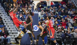 New Orleans Pelicans guard Jrue Holiday (11) scores against the Los Angeles Clippers during the first half of an NBA basketball game in New Orleans, Thursday, Nov. 14, 2019. (AP Photo/Sophia Germer)