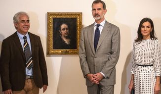 Spain&#39;s King Felipe and Queen Letizia pose for photos standing next to a self-portrait of Spanish painter Francisco de Goya, accompanied by the museum director Jorge Fernandez, at the Bellas Artes Museum in Old Havana, Cuba, Thursday, Nov. 14, 2019. (AP Photo/Ramon Espinosa, Pool)