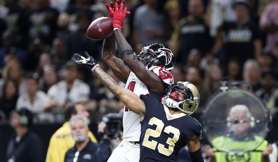 Atlanta Falcons wide receiver Julio Jones (11) tries in vain to pull in a pass in the end zone over New Orleans Saints cornerback Marshon Lattimore (23) in the first half of an NFL football game in New Orleans, Sunday, Nov. 10, 2019. (AP Photo/Rusty Costanza)