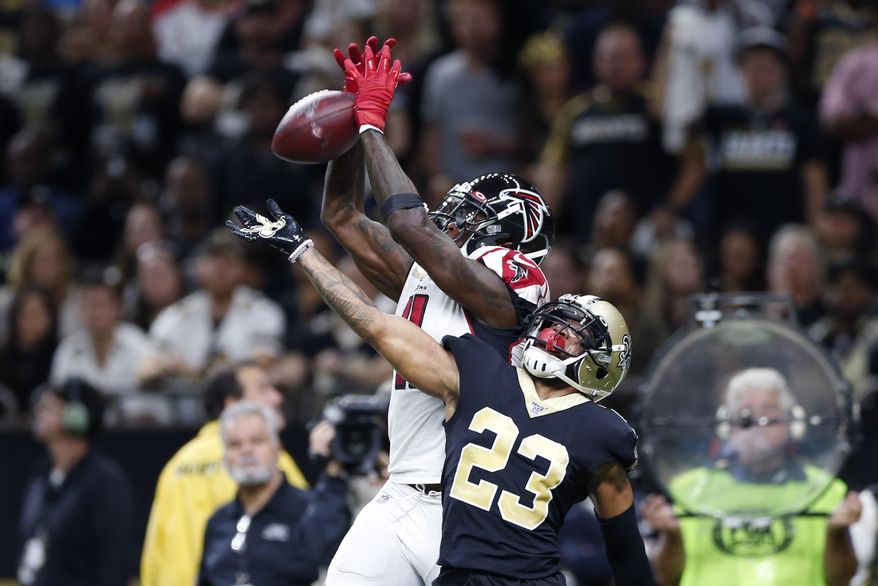 Atlanta Falcons wide receiver Julio Jones (11) tries in vain to pull in a pass in the end zone over New Orleans Saints cornerback Marshon Lattimore (23) in the first half of an NFL football game in New Orleans, Sunday, Nov. 10, 2019. (AP Photo/Rusty Costanza)
