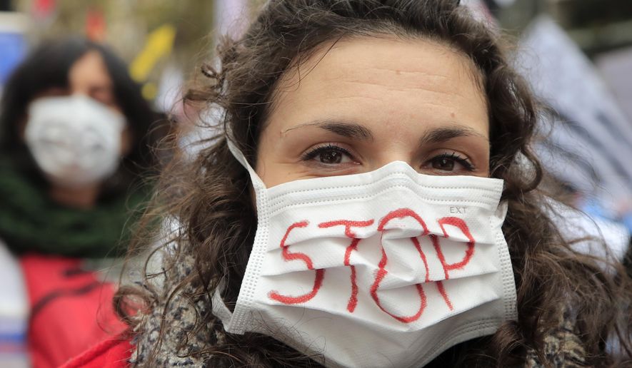 A medical staff wears a mask during a national demonstration Thursday, Nov. 14, 2019 in Paris. Among the demands being made are more staff , pay rises, in particular for those on low salaries, and providing more beds. (AP Photo/Michel Euler)